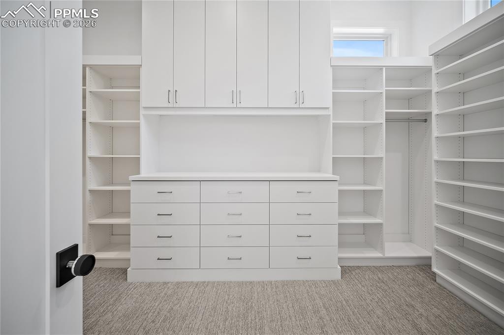 Beautiful cabinets in primary master closet. 