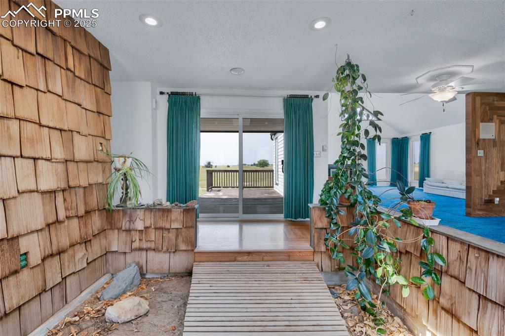 The entry is designed to be an indoor garden. The bridge is a hard wood a few inces above the garden space.