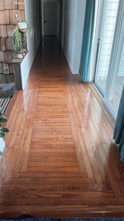 Entry hard wood floor detail. On the left is the entry bridge, on the right is a slider to a partially covered deck.