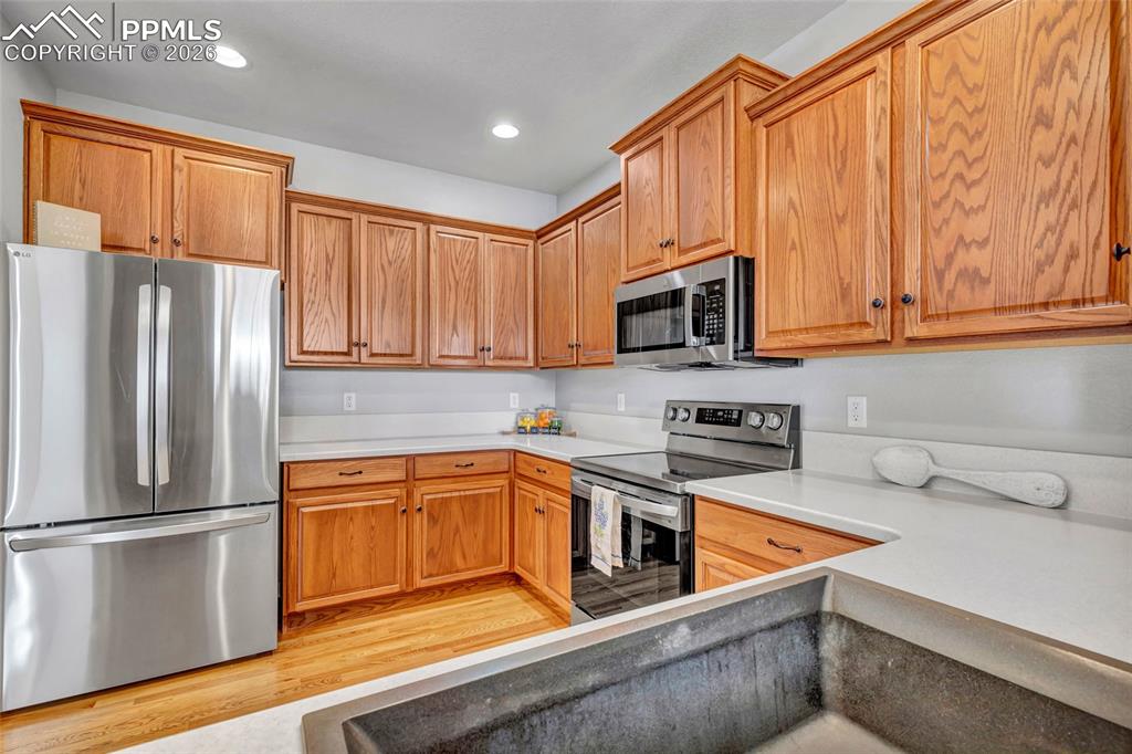 Remodeled kitchen with Corian countertops, new sink, and stainless steel appliances