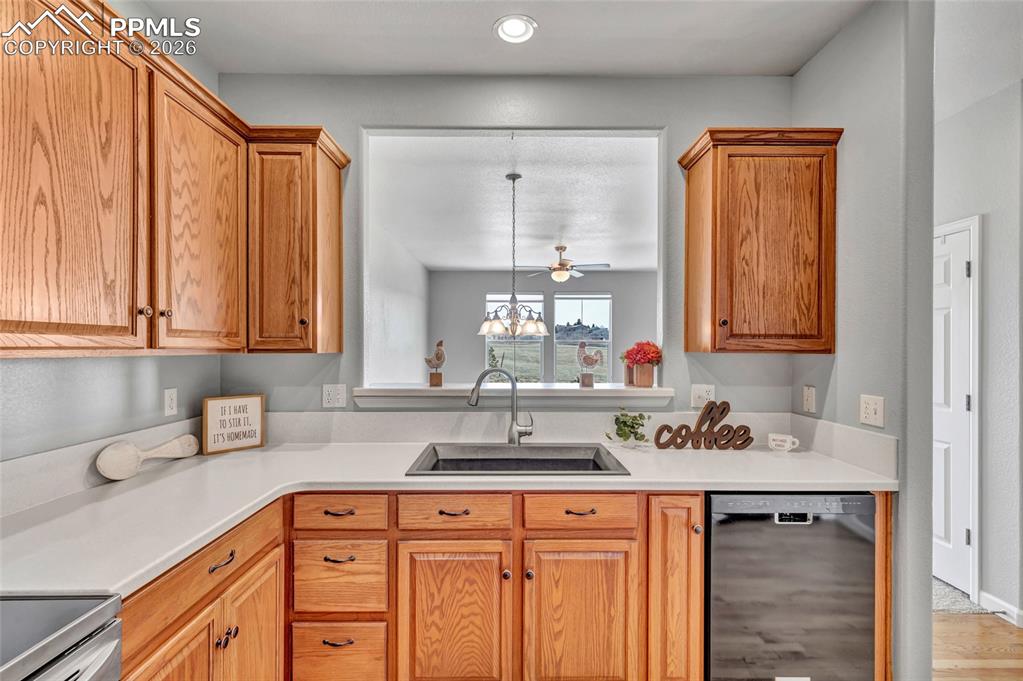 Remodeled kitchen with Corian countertops, new sink, and stainless steel appliances