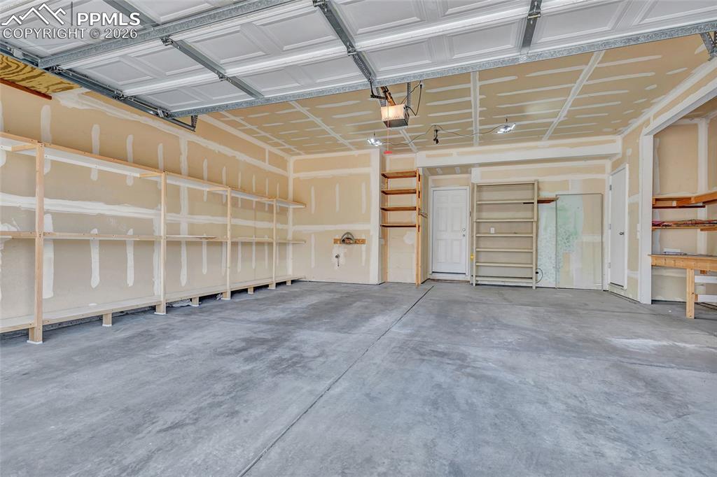 2 car garage with built-in storage and workbench area