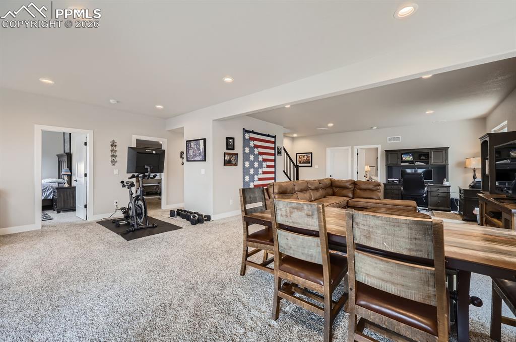 Dining space featuring recessed lighting, baseboards, stairway, and light colored carpet