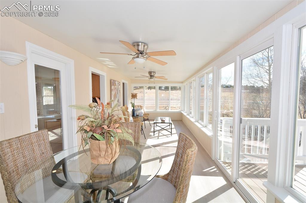 Bright and inviting sunroom with room for a table and sitting area overlooking the backyard