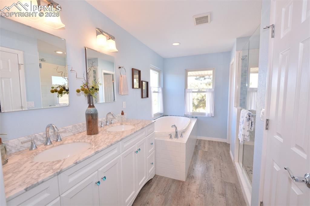 Master Bathroom with double vanity, spa shower with bench seat and soaking tub