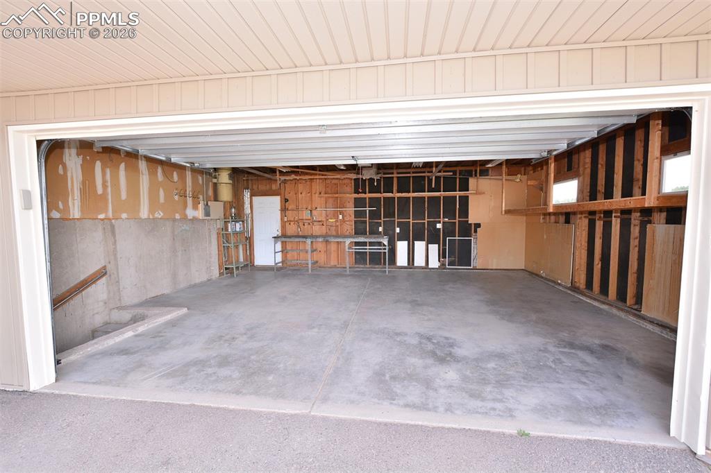 Oversized garage with workbench and overhead storage