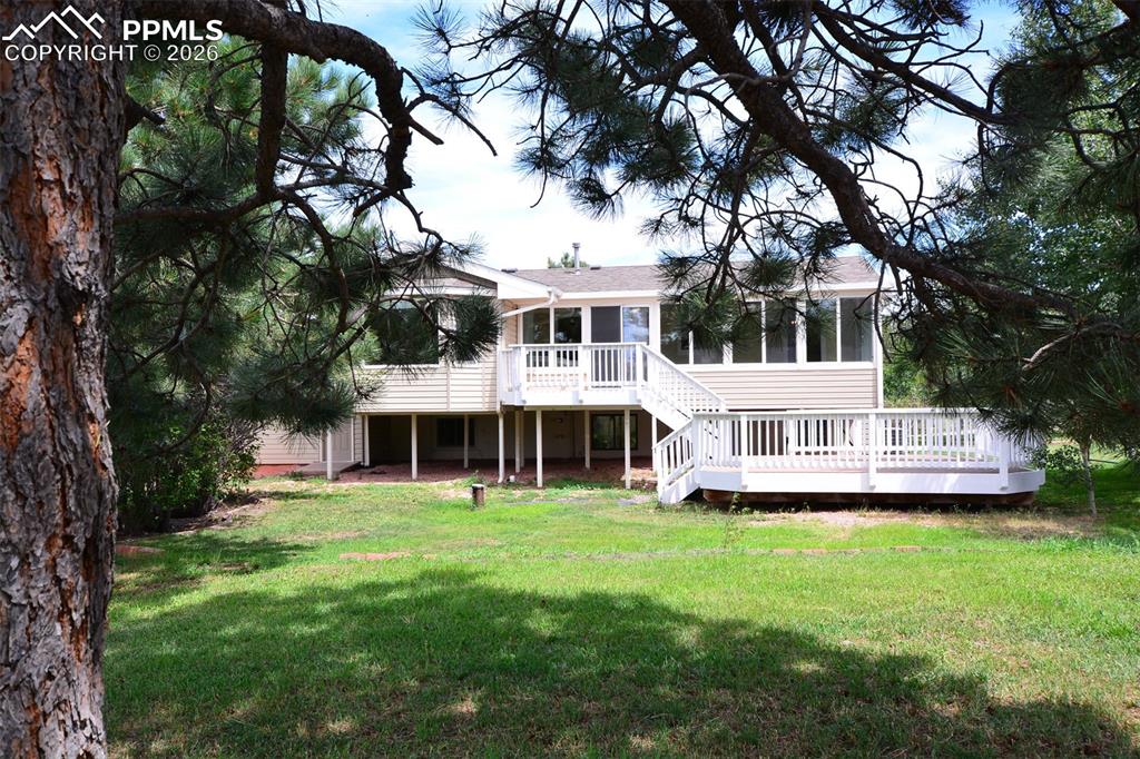 Back side of home with mature trees