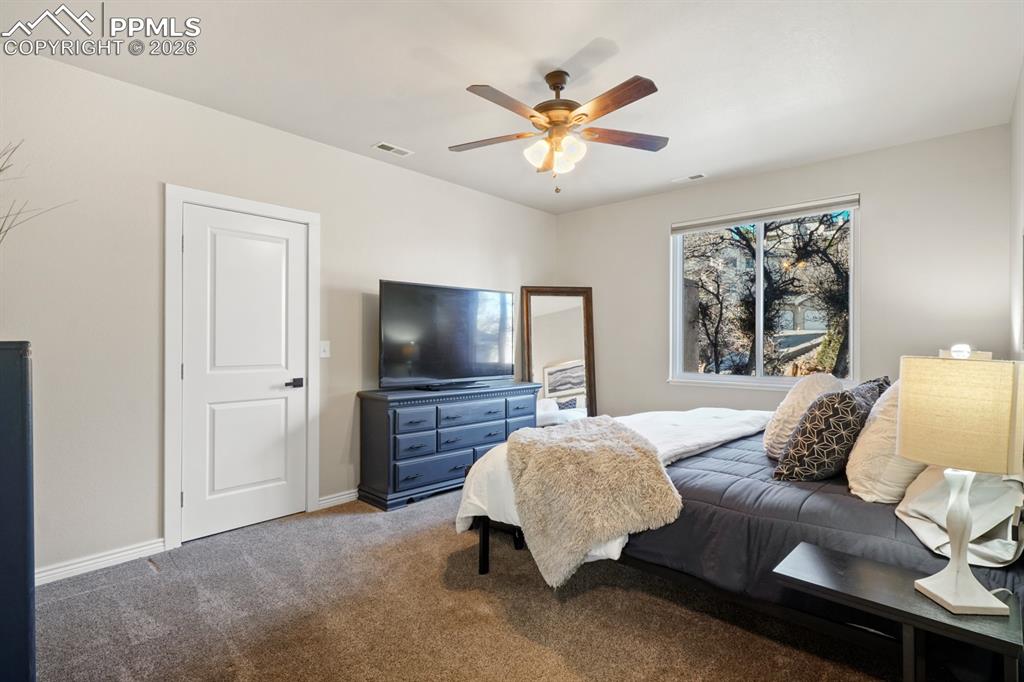 Bedroom featuring ceiling fan and carpet floors