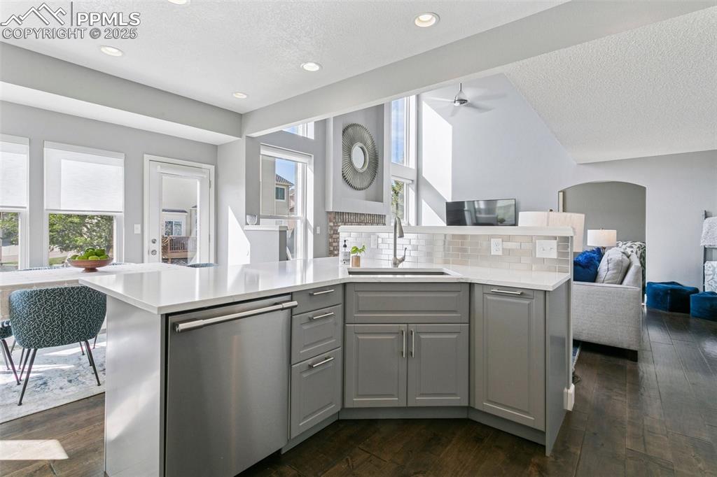Large kitchen island w/quartz counters, farmhouse sink and a stainless steel dishwasher!
