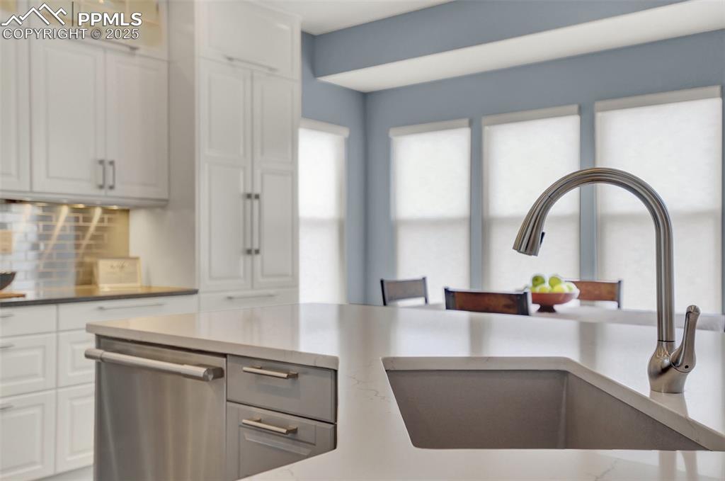 Custom granite farmhouse sink at the kitchen island