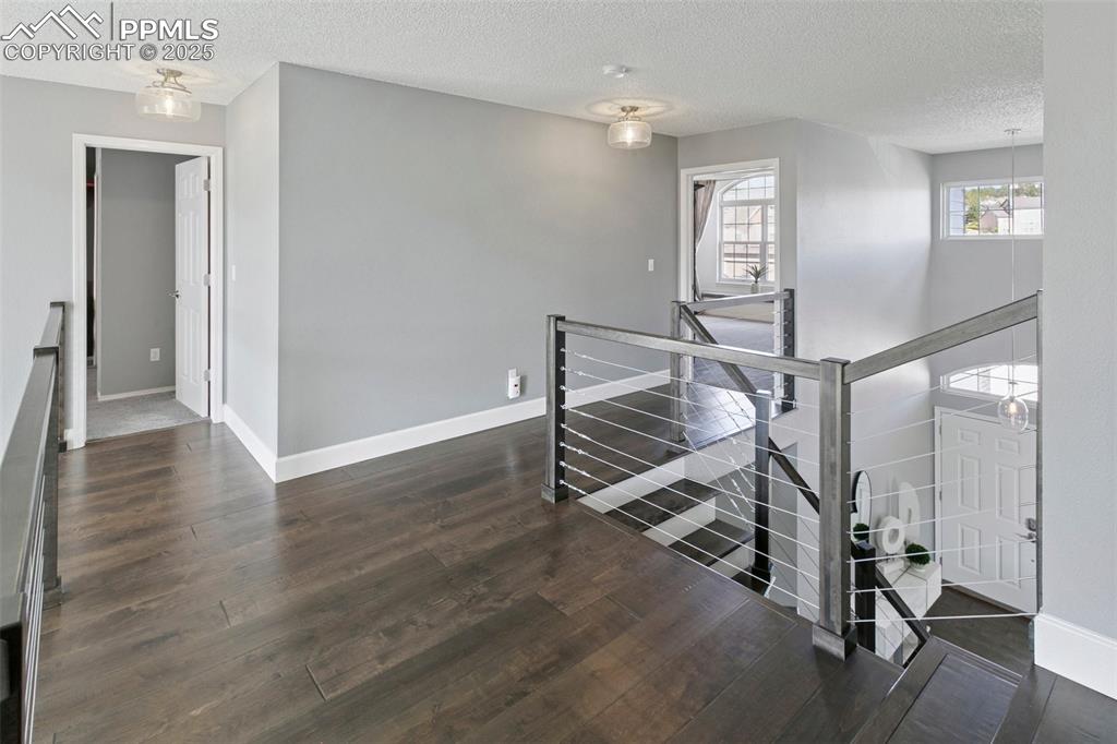 Upper-level landing opens to both the front and the back of the home.