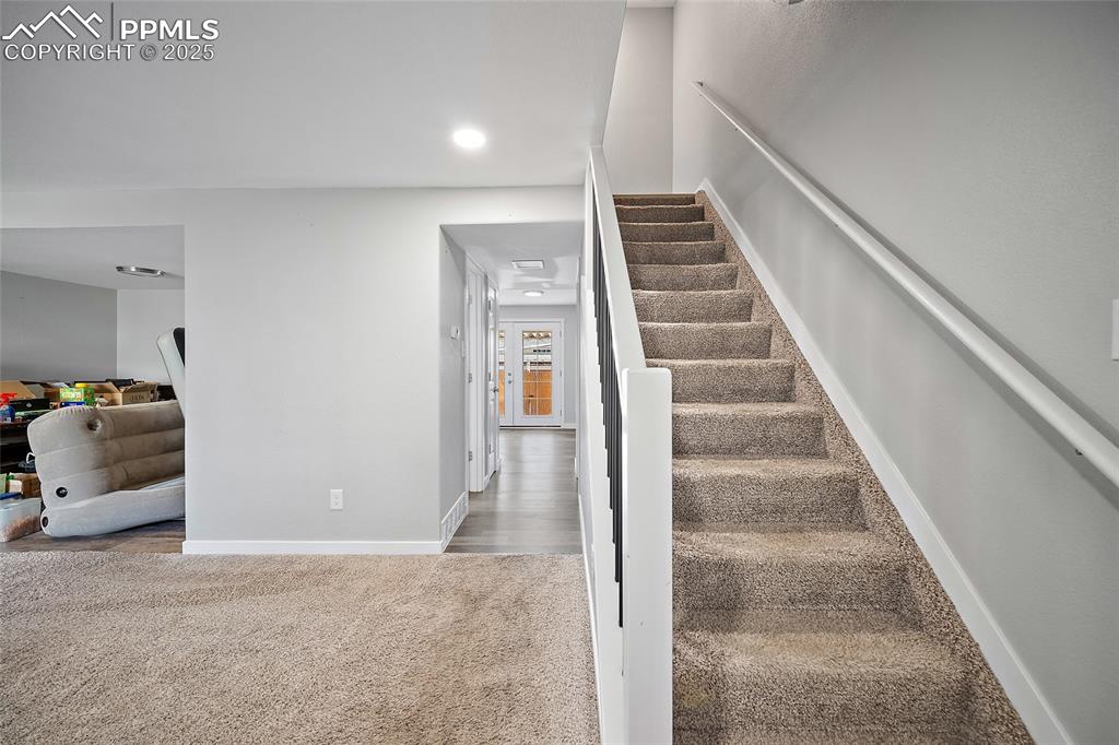 Staircase featuring carpet floors and recessed lighting