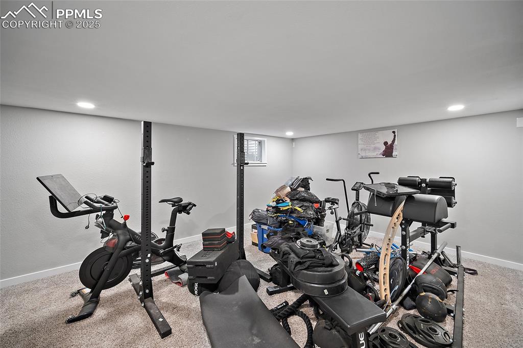 Workout room with light carpet and recessed lighting
