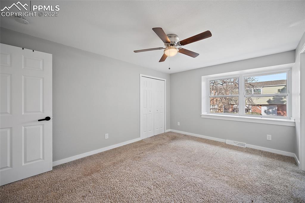 Unfurnished bedroom with carpet floors, a closet, and ceiling fan