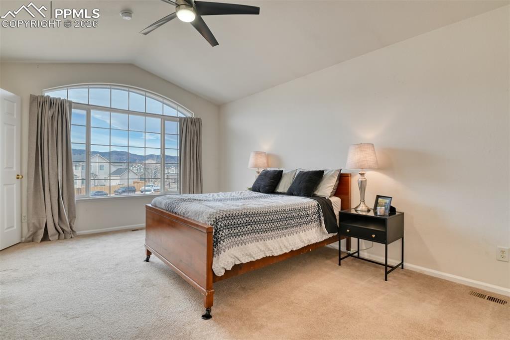 Primary bedroom is spacious and has ceiling fan. 