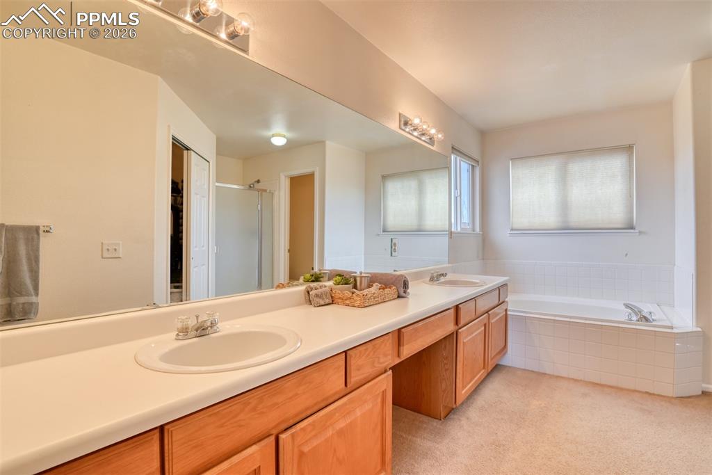 Primary bathroom has double sinks, plenty of counter space, soaking tub and separate shower. 