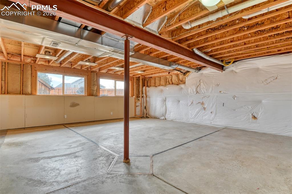 Largely unfinished basement with garden level windows looking out to the large backyard. 