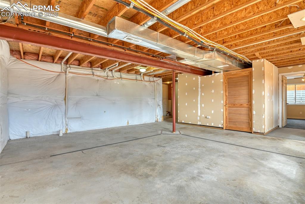 Basement is roughed in for additional bathroom...unfinished office to the left, door to mechanical room in the middle and bedroom #5 to the right. 