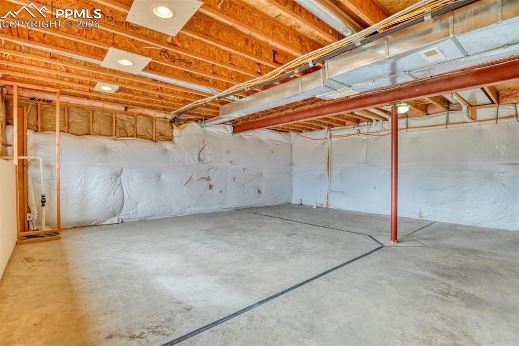 Another view of the unfinished basement. 