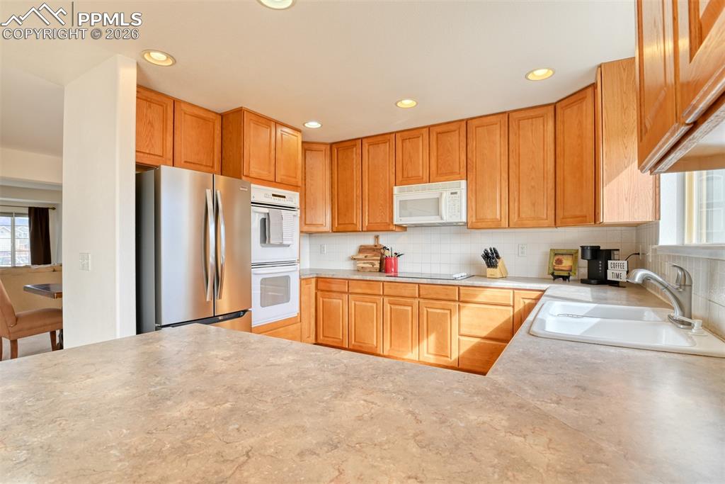 Kitchen is spacious and has counter bar for extra seating. 