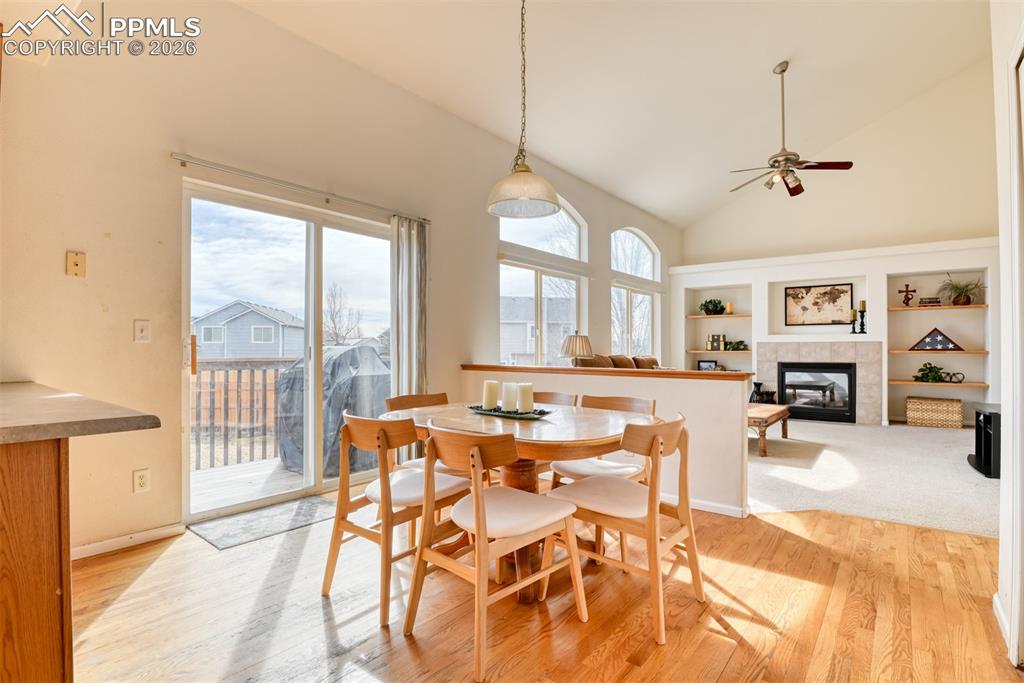Kitchen is open to the great room with vaulted ceilings, gas fireplace,built in shelves and fan. 