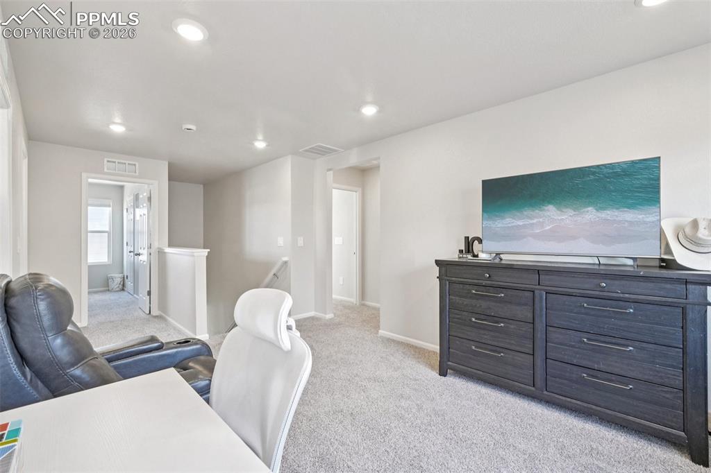Office area featuring light carpet and recessed lighting