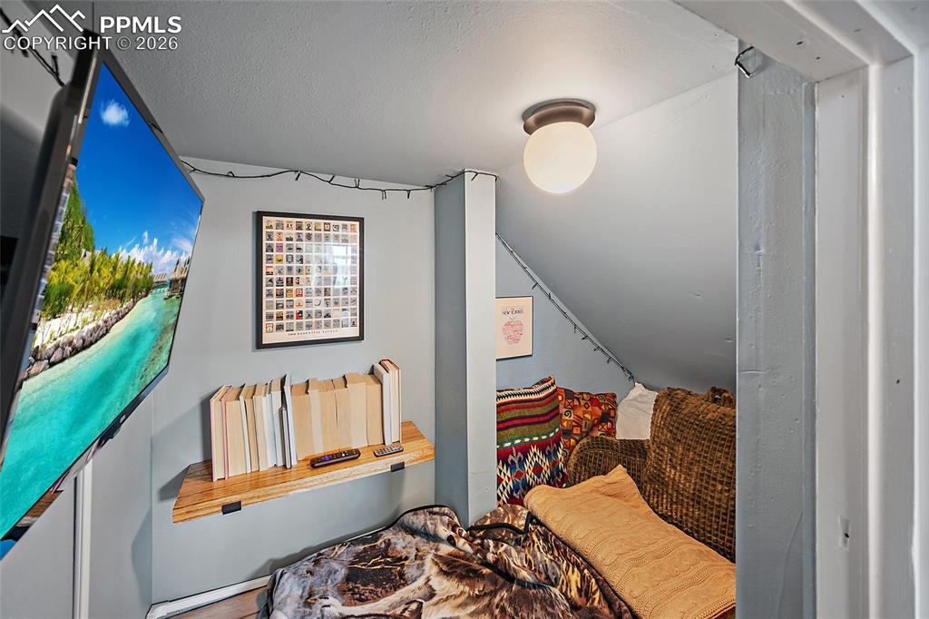 Custom under-stair alcove transforms often-wasted space into an inviting entertainment hidaway