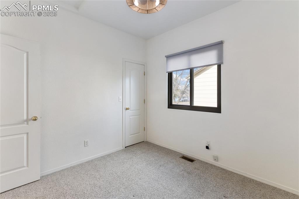 Spare room with baseboards and carpet floors
