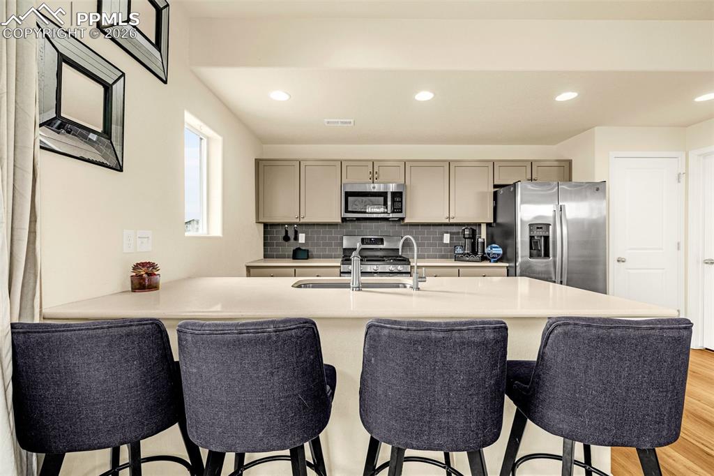 kitchen offers breakfast bar with quarts counter top