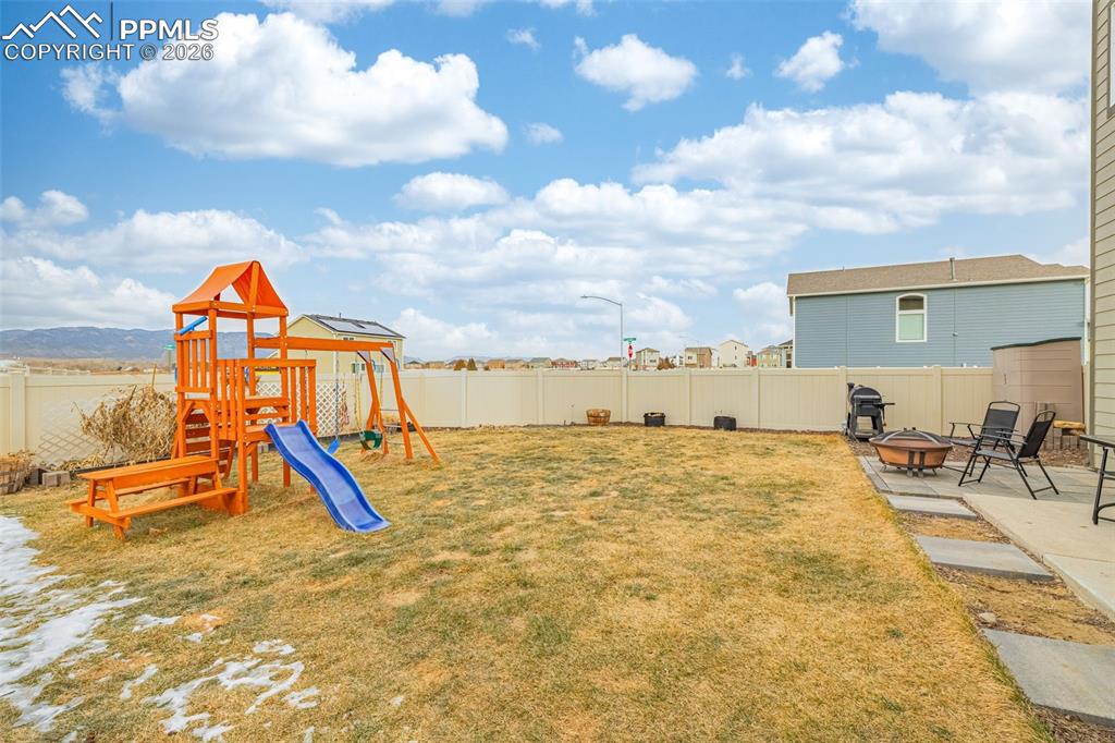 Spacious back yard with grass and mountain views