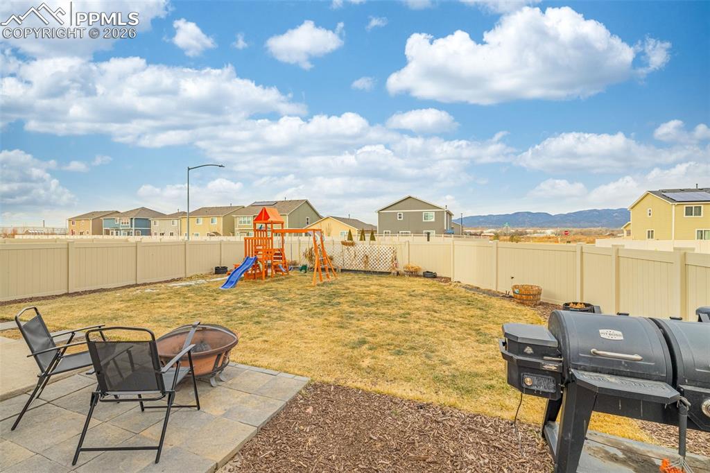 Spacious back yard with grass and mountain views