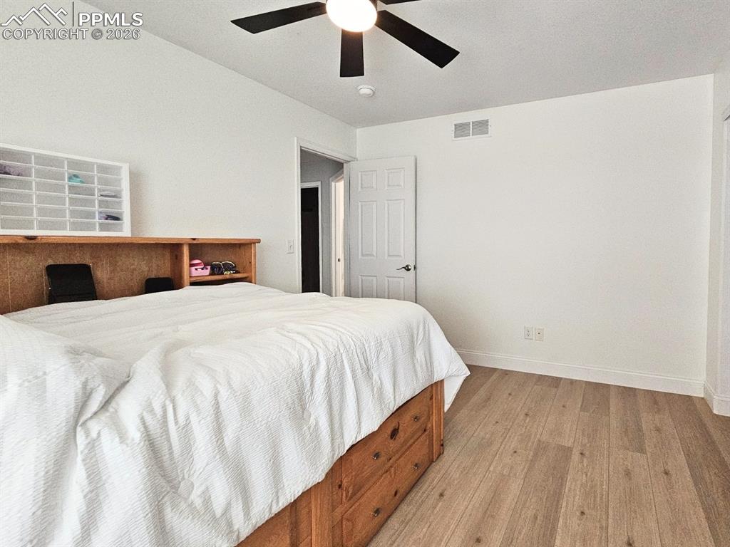 Bedroom (4) with Ceiling Fan and Plank Floor - Closet doors on site.