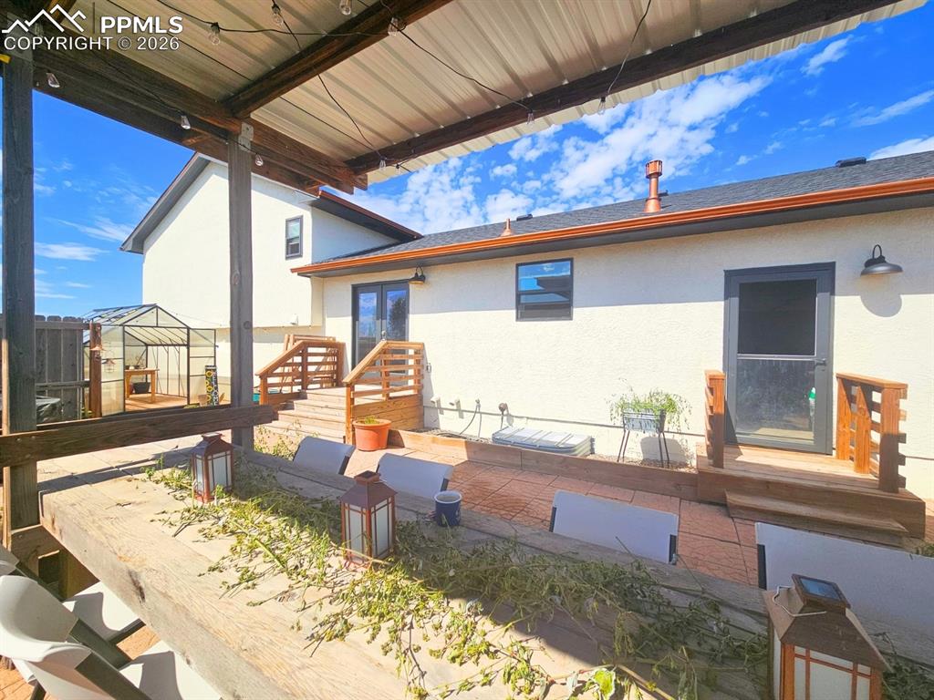 Expansive and private deck with Cedar Beamed Table and Galvanized Metal Cover with Lights