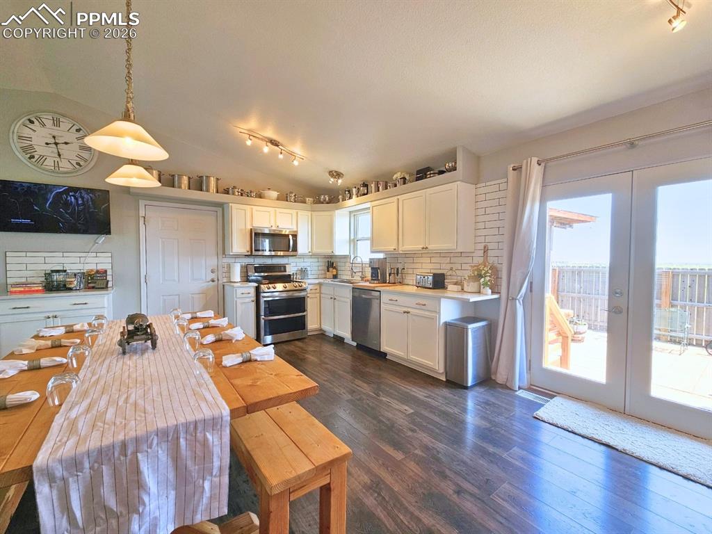Kitchen with Quartz Countetops, Plank Floor, Stainless Steel Appliances, farmhouse cabinets, french doors