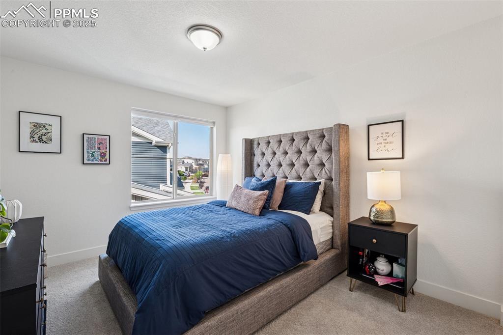 Carpeted bedroom with baseboards