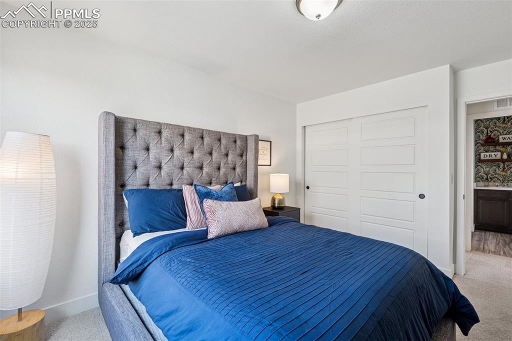 Bedroom featuring carpet floors and a closet
