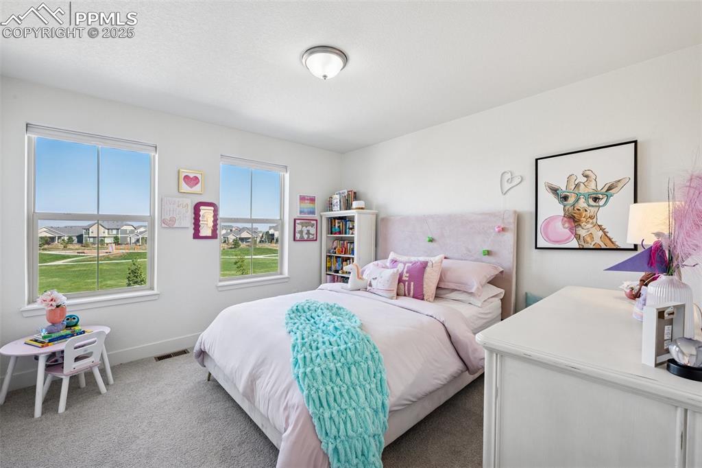 Carpeted bedroom featuring baseboards
