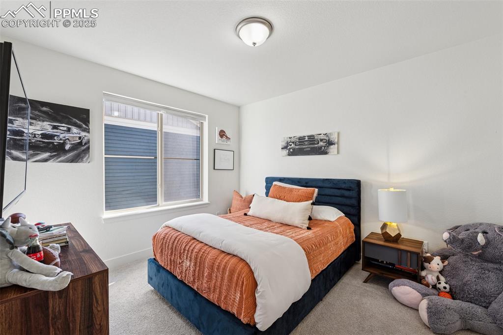 Bedroom with carpet floors and baseboards