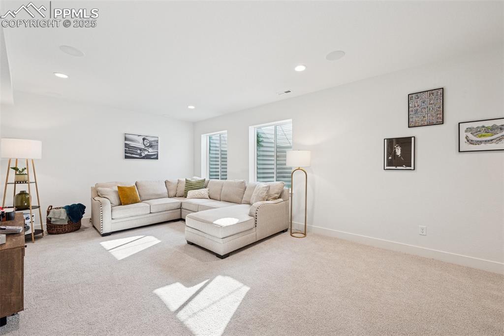 Living room featuring light colored carpet and recessed lighting