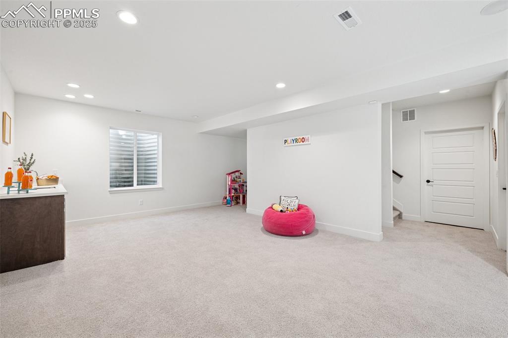 Rec room with recessed lighting and light colored carpet