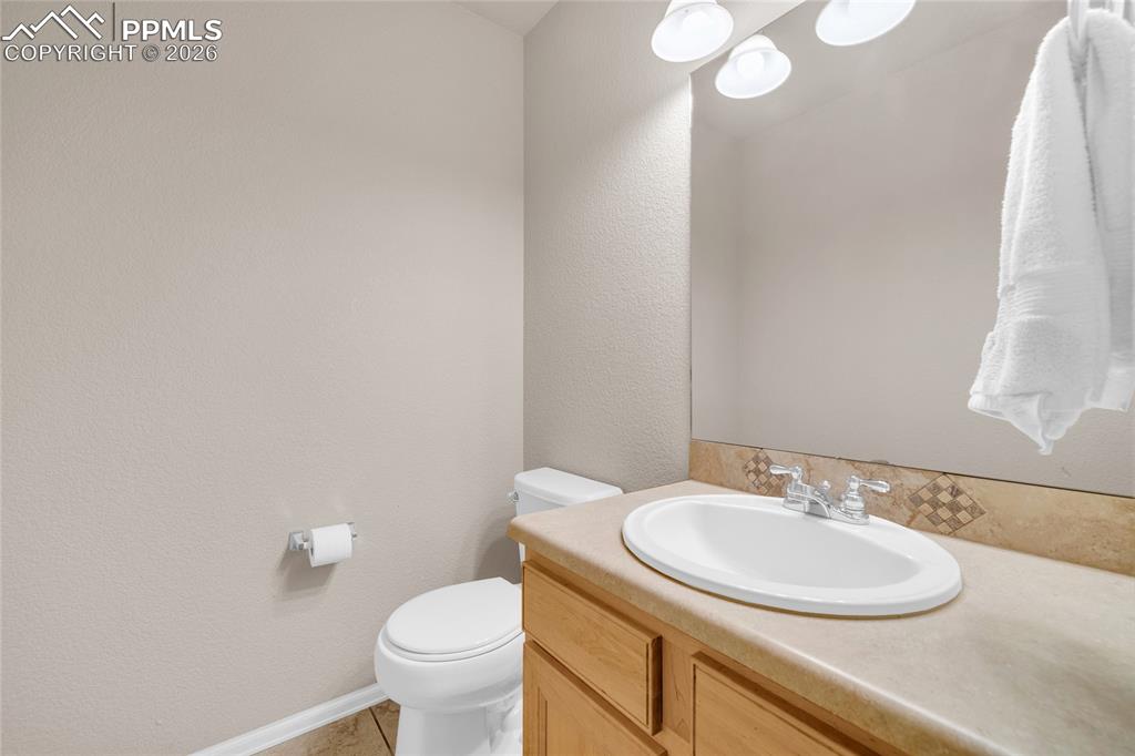 Bathroom featuring vanity and a textured wall
