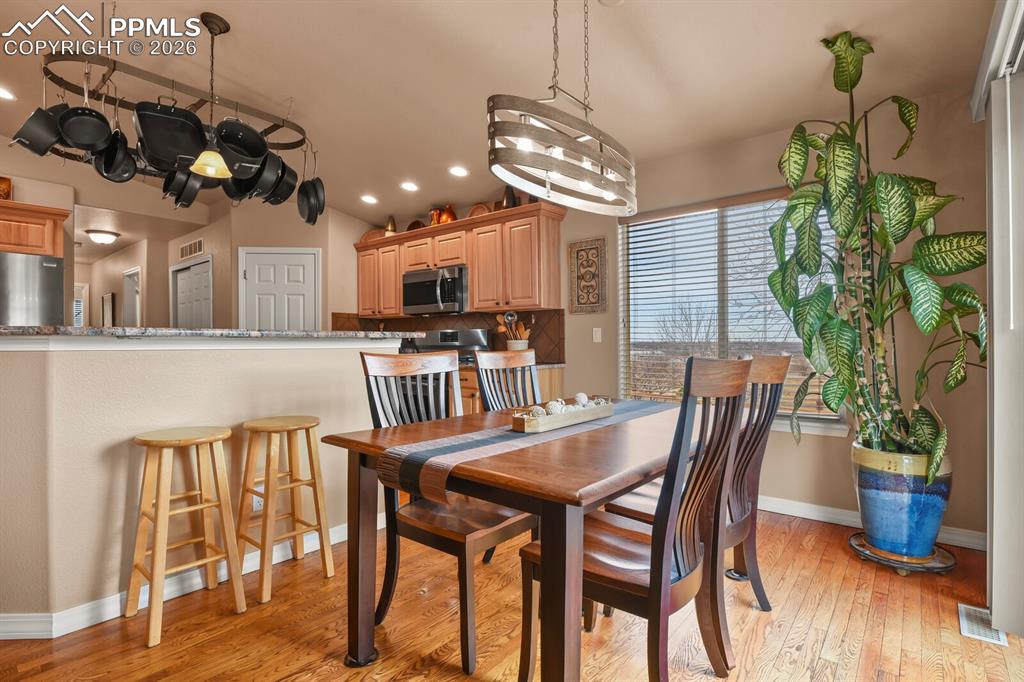 Dining area with hardwood wood floors, recessed lighting and slider to the backyard and patio area.