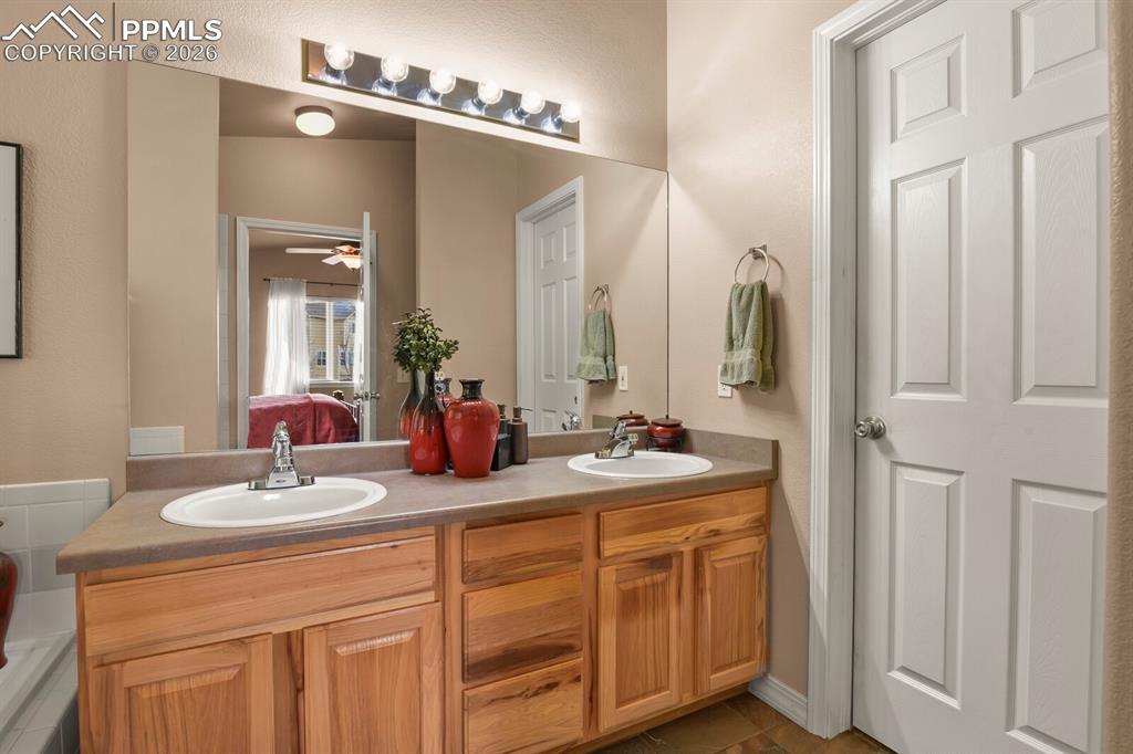 Ensuite bathroom to the Primary Bedroom  with double vanities and door to the walkin closet