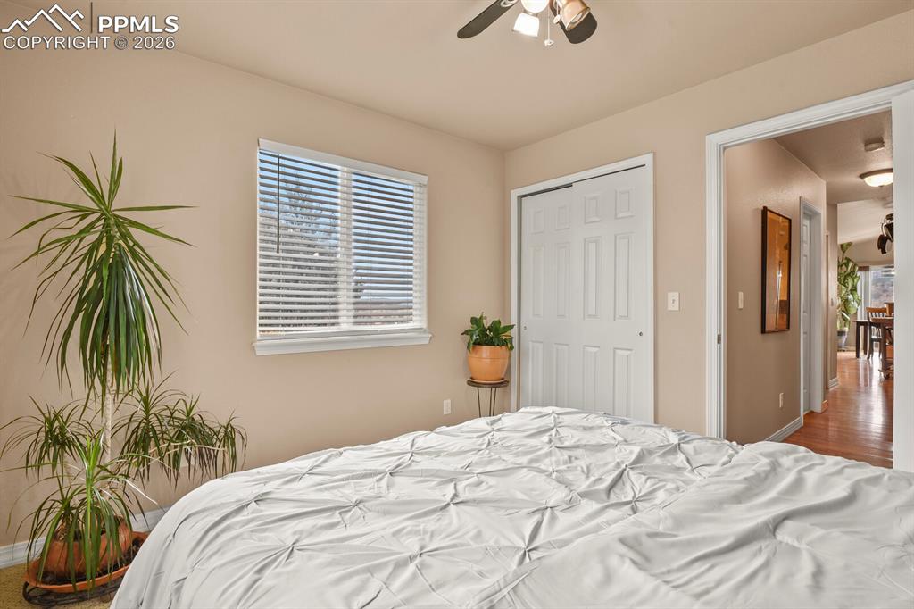 Third bedroom on the main level,  featuring a ceiling fan and a closet