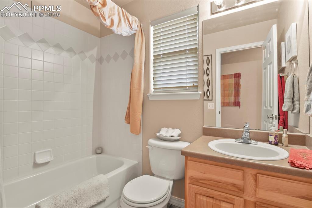 Main level bathroom featuring vanity and shower / bathtub combination