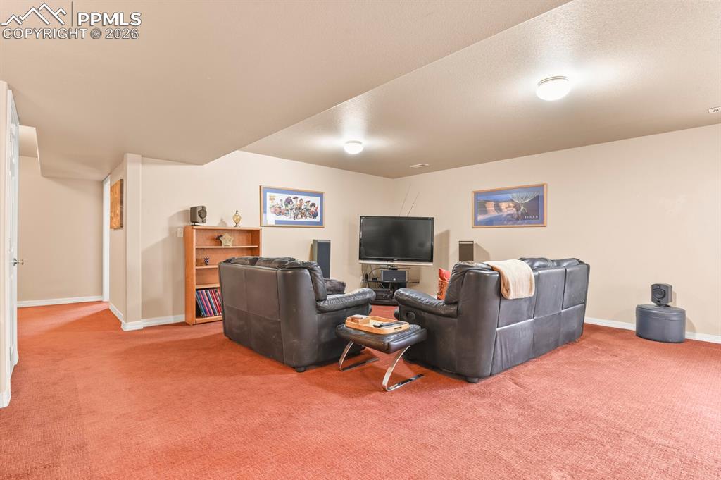 Carpeted living room with baseboards
