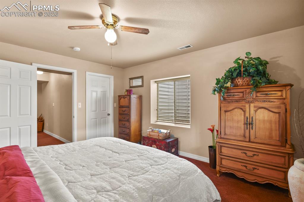 4th Bedroom in the basement  with a ceiling fan and dark carpet