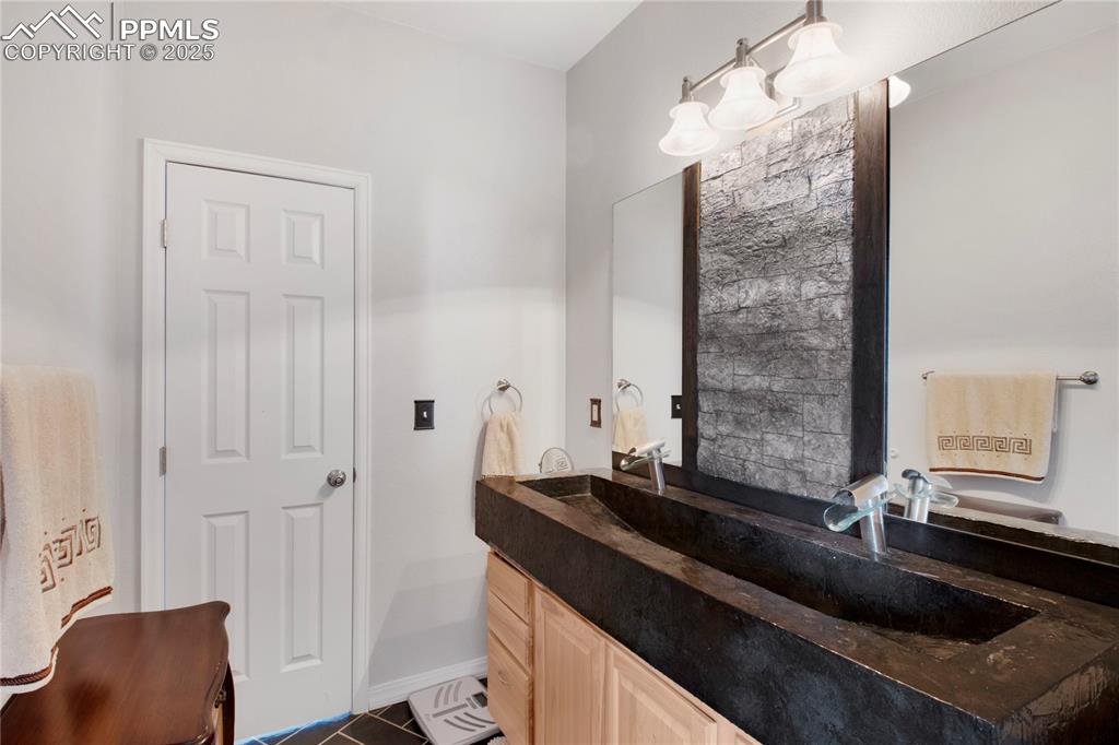 Bathroom featuring vanity and baseboards