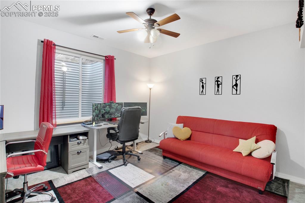 Office with baseboards and a ceiling fan