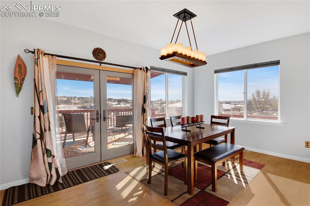 Dining area featuring wood finished floors, french doors, and baseboards
